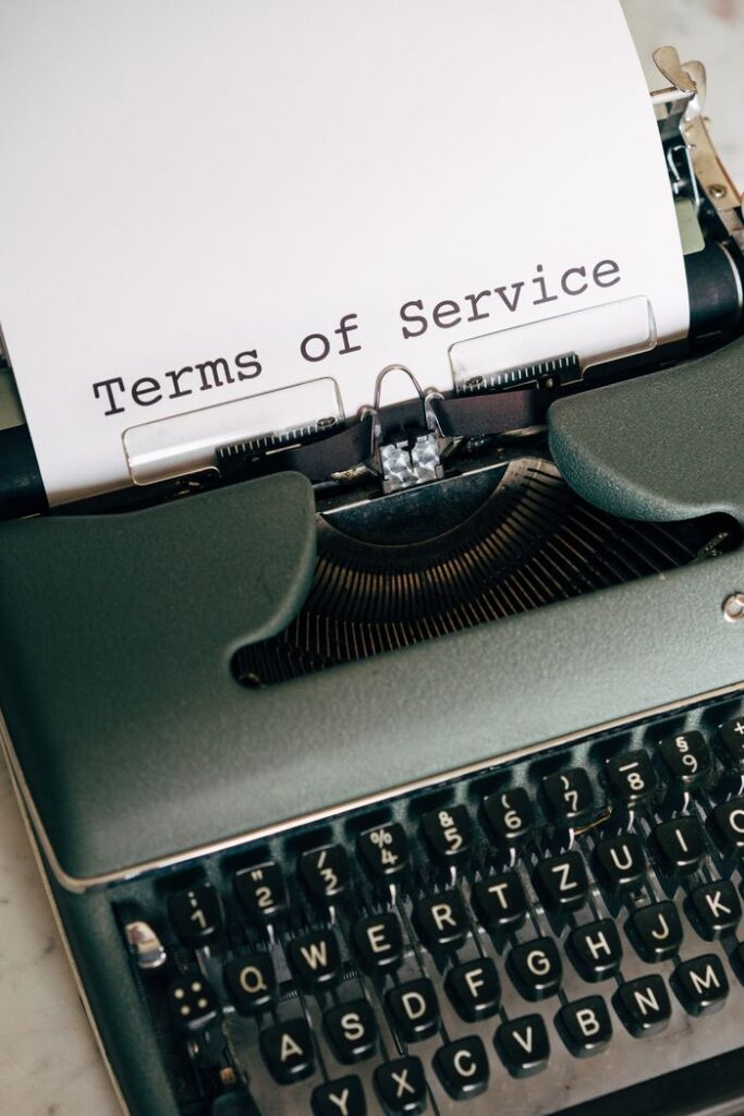 Crafting Captivating Headlines: Your awesome post title goes here Close-up of a vintage typewriter typing 'Terms of Service' on paper.